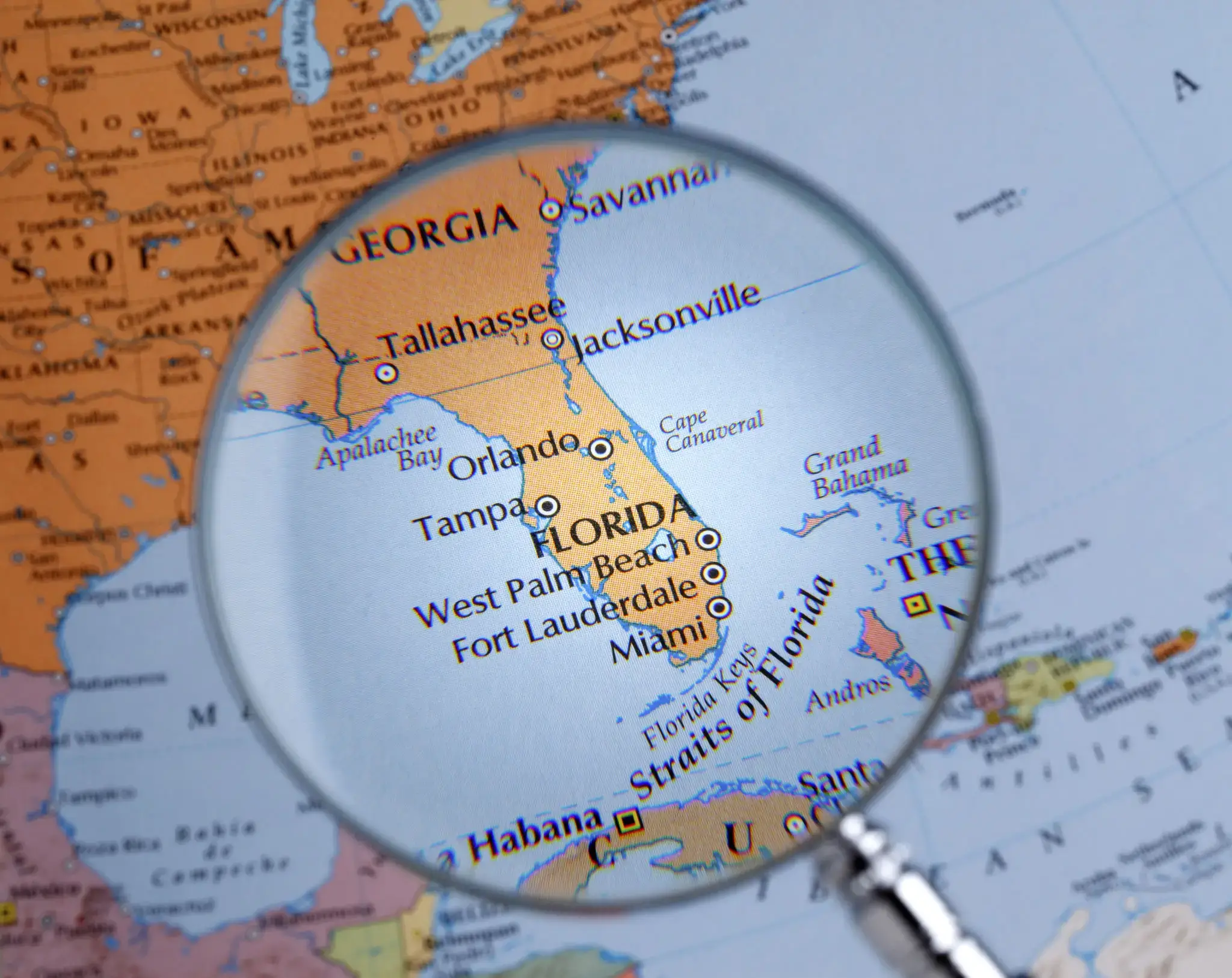 Magnifying glass over Florida on a map.