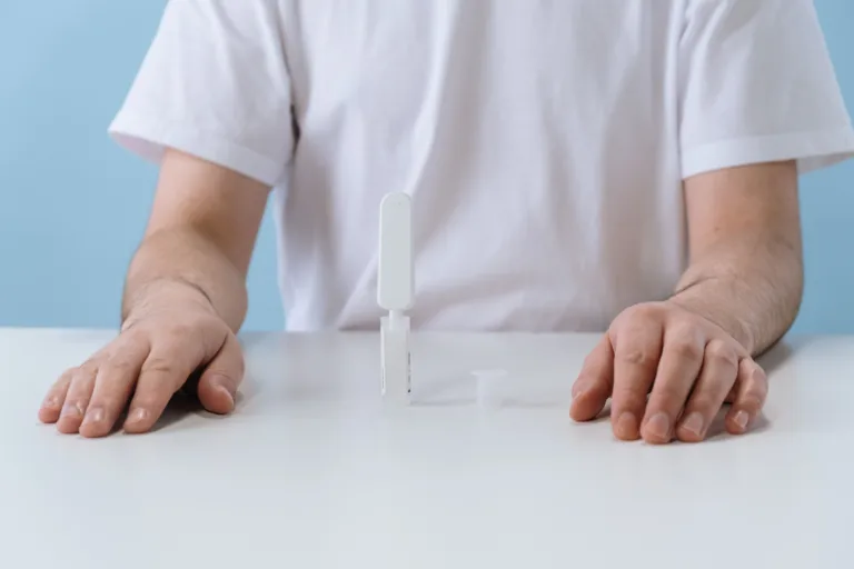 Person using an OraQuick HIV rapid self-test kit at a table