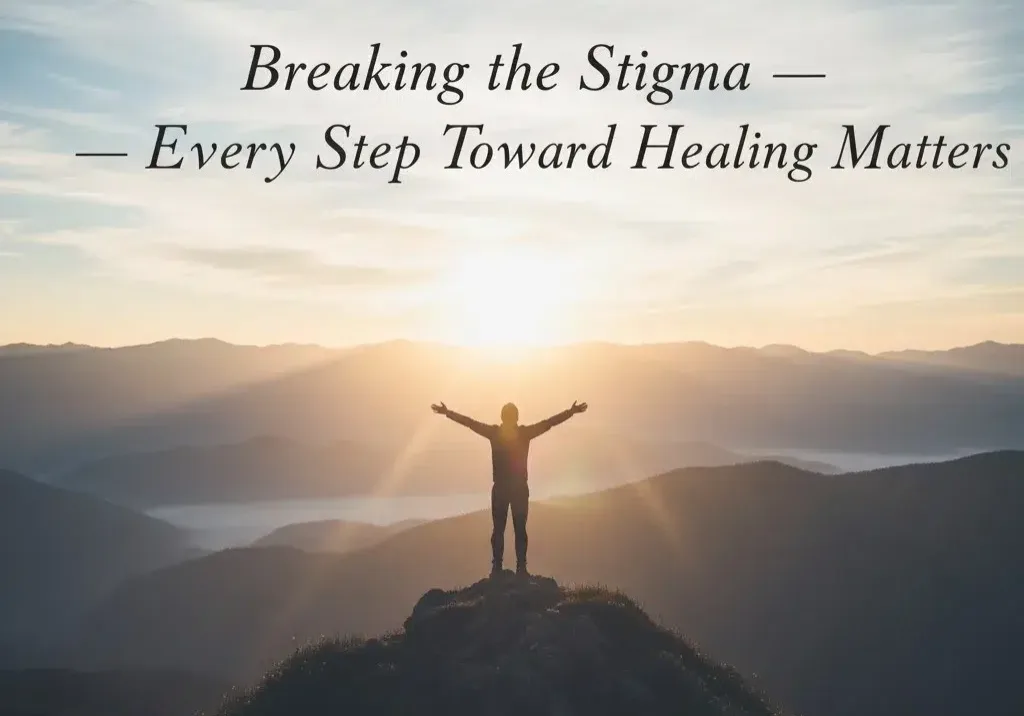 Person standing on mountain, sunrise background.